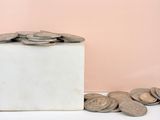 a white box filled with coins sitting on top of a table