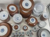 many different types of plates and bowls on the table