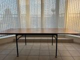 a table in the middle of a room with a window in the background