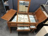 a small wooden table with a mirror on top of it