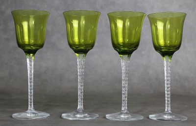 quatre verres à vin verts posés sur une table