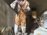a statue of a man that is standing next to a mirror