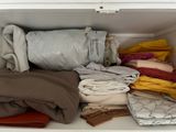 a picture of a closet full of clothes and blankets