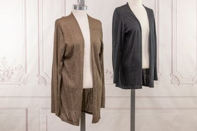 two mannequins in front of a white wall and a brown and black jacket on a mannequin stand
