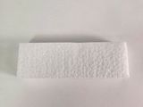 a white piece of paper on a white surface next to a pair of scissors