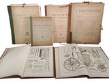 several old books are sitting on top of each other on a table