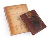 an old book sitting on top of a wooden box next to a book