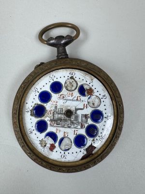a pocket watch that has a picture of a train on it