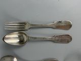 four spoons and a fork on a table