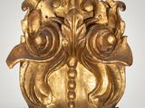 an image of a gold sculpture of a face on a white background