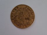 une pièce d'or sur laquelle figure l'image d'un homme