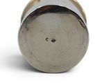 a metal object that is sitting on a white surface