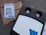 a box that has a monitor and a box with some papers on it