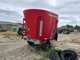 an image of a red tractor trailer parked in a field
