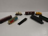 several toy trains are lined up on a white surface