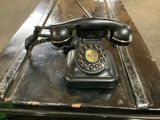 a black telephone sitting on top of a table