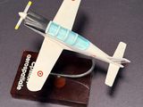 a toy airplane that is sitting on top of a wooden stand