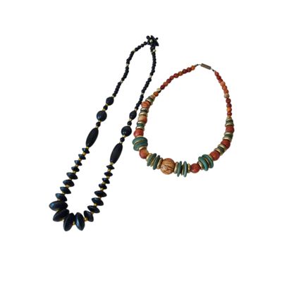 a close up of a necklace and a bracelet on a white background