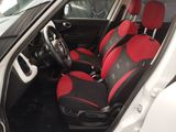 the interior of a car with red and black seats and a steering wheel