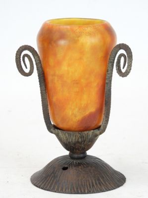 a vase that is sitting on a stand on a white surface