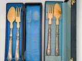 two forks and a spoon in a blue box