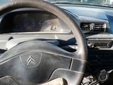 dashboard of a car with a steering wheel and dashboard controls