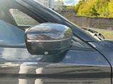 a reflection of a person in the side mirror of a car