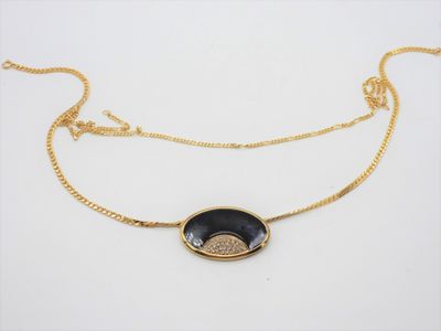 a black and gold necklace with a coin on a gold chain