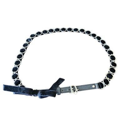 a close up of a dog collar with black beads on it