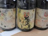 three bottles of wine sitting on top of a cardboard box