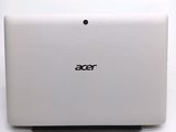 the back of a white laptop computer sitting on top of a white table