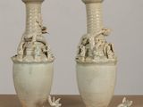 two vases that are sitting on a table
