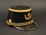 a black hat with gold trim and a red ribbon