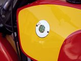 a red and yellow motorcycle parked on the street