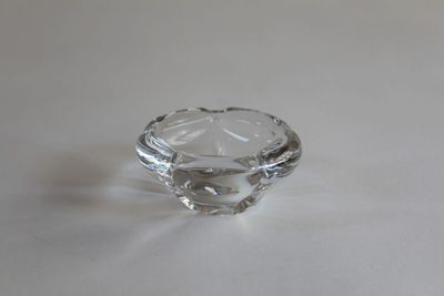 a clear glass ring on a table with a white background