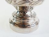 a silver plate with a bird on top of it