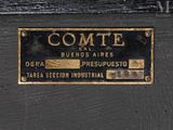 black and gold sign on the door of a building that says comite