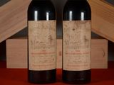 two bottles of wine sitting next to each other on a table