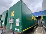 a large green truck that is parked in a parking lot