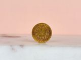 a gold coin sitting on top of a marble counter top