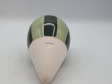 a small green and white object on a white surface