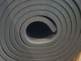 a roll of black foam sitting on top of a cardboard box