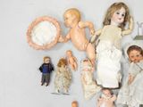 a lot of dolls that are sitting on a table