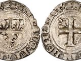 a silver coin with an image of a cross on it