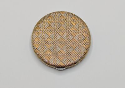 a close up of a small metal object on a white surface
