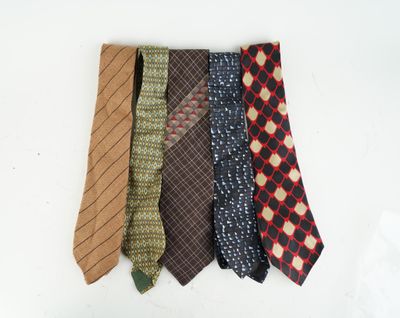 four different colored ties are lined up on a white surface