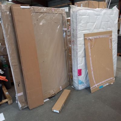 many boxes of mattresses and other items in a warehouse