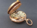 a gold pocket watch with a chain attached to it