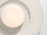 a white plate with a candle in it on a table