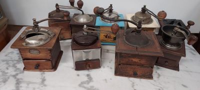 many different types of coffee grinders on a table